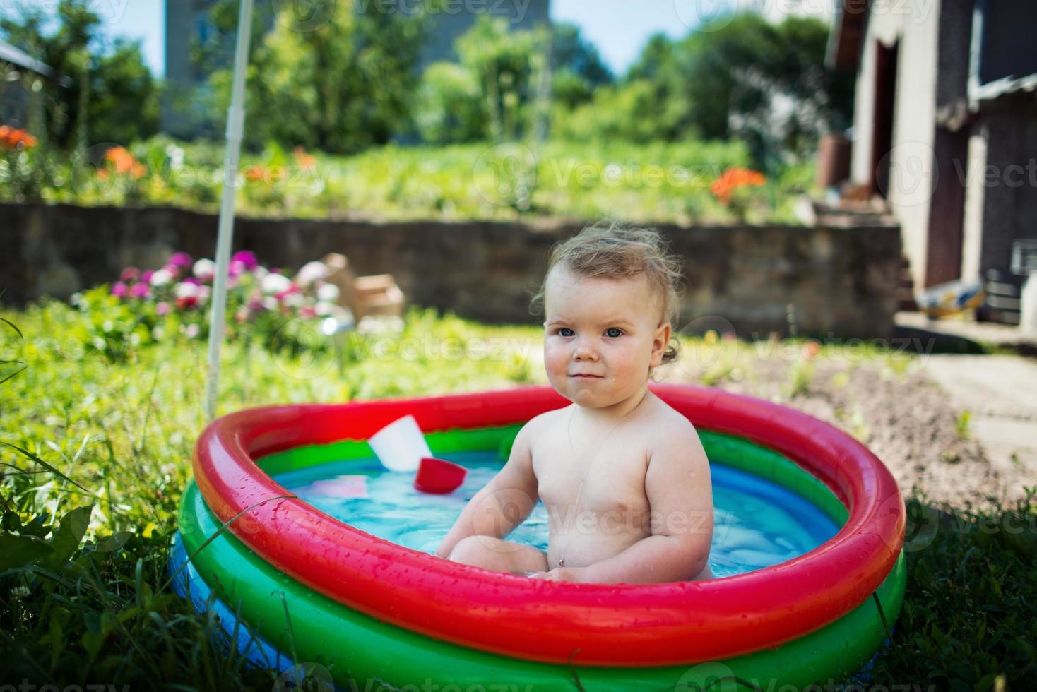 Little girl swimming in pool photo