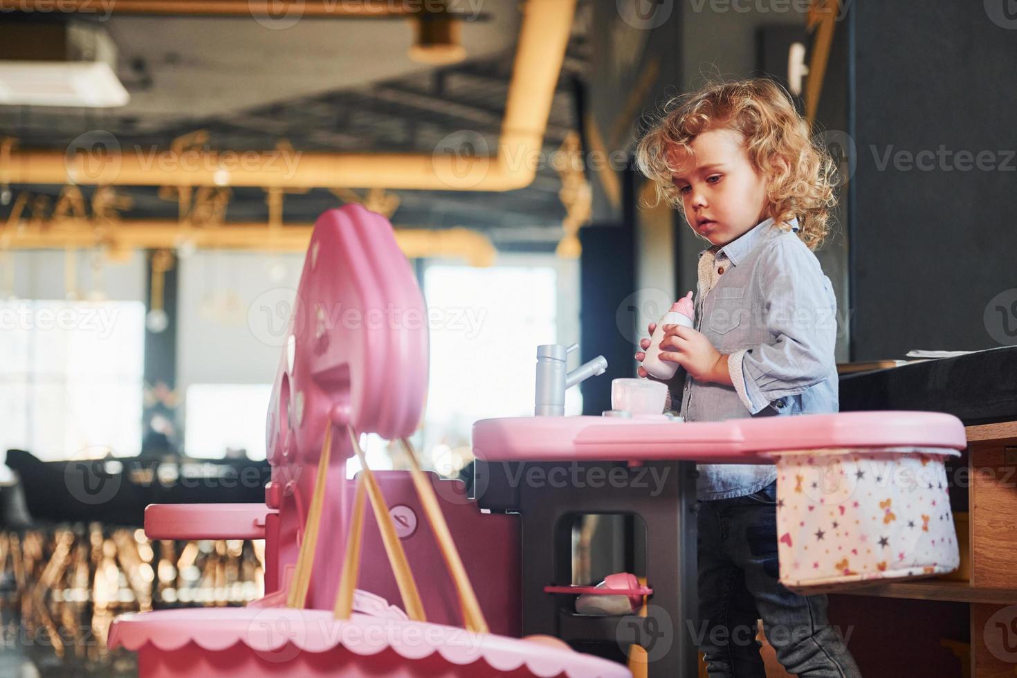 Child have fun in playroom. Kindergarten educational games photo