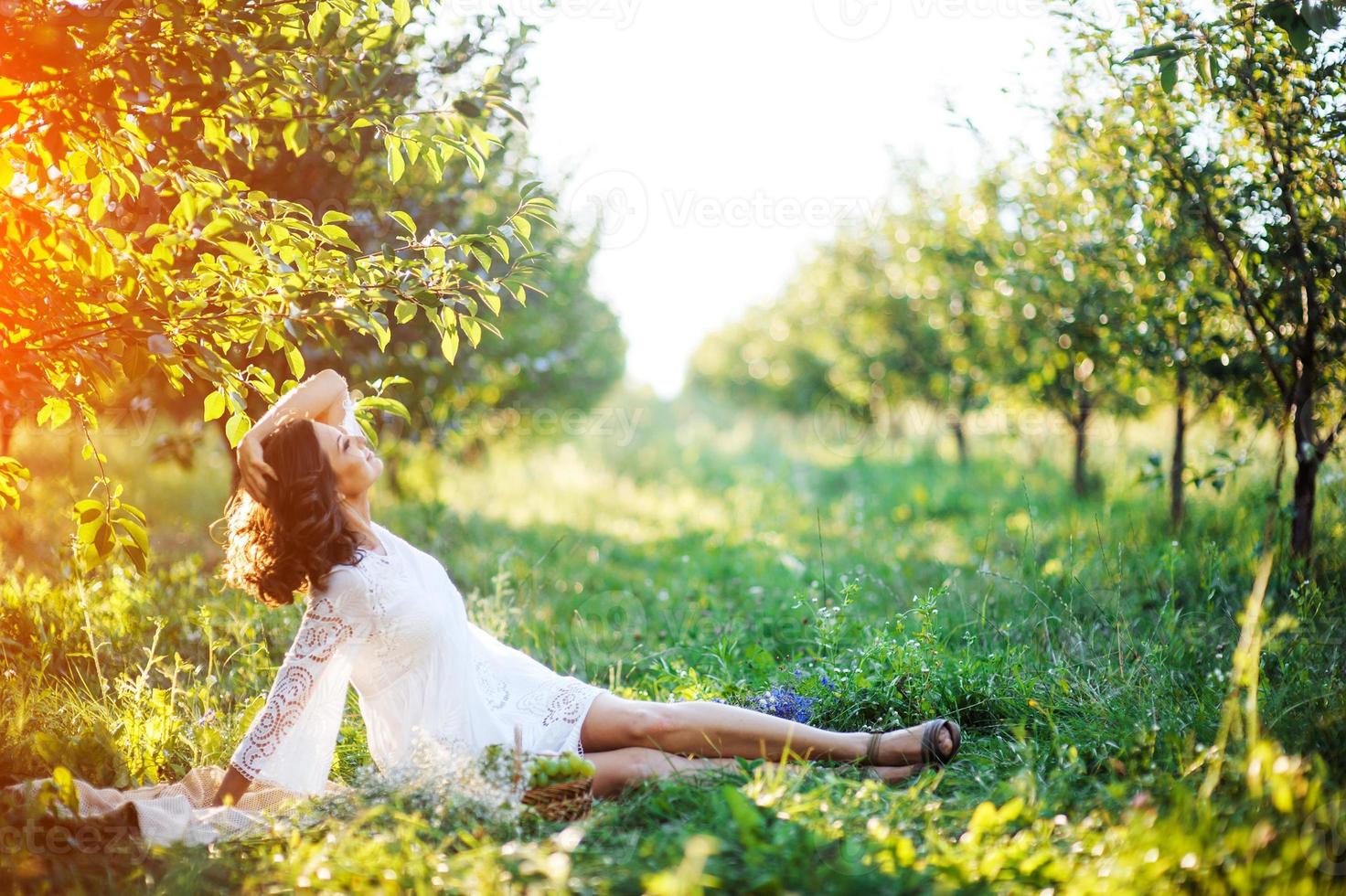 beautiful young woman with flower wreath in the garden photo