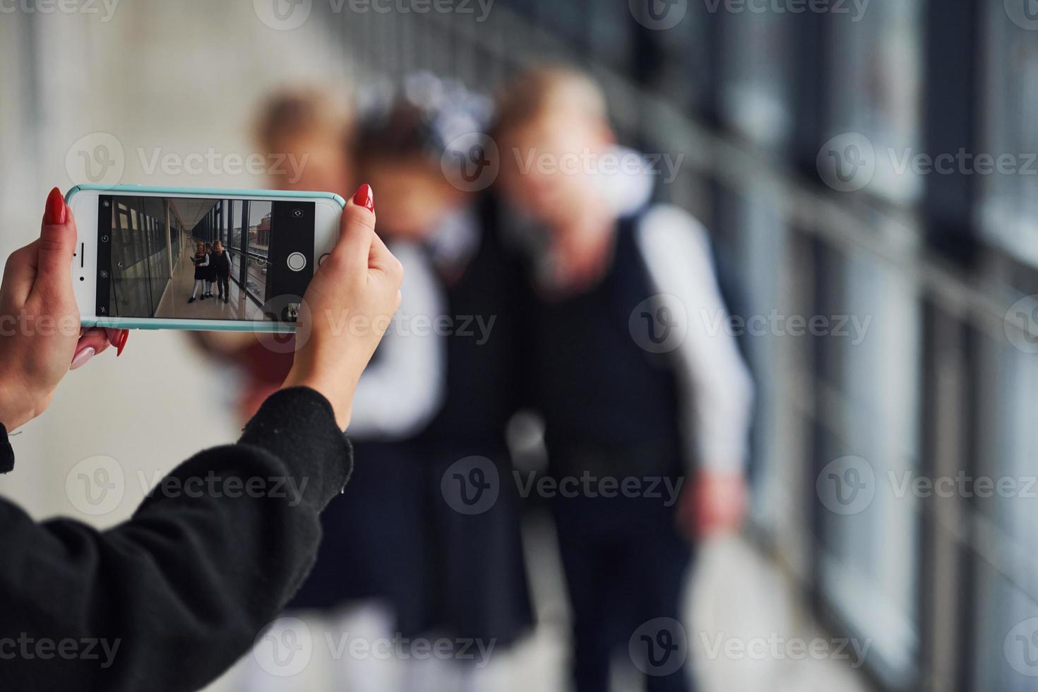 School kids in uniform making a photo together in corridor. Conception of education