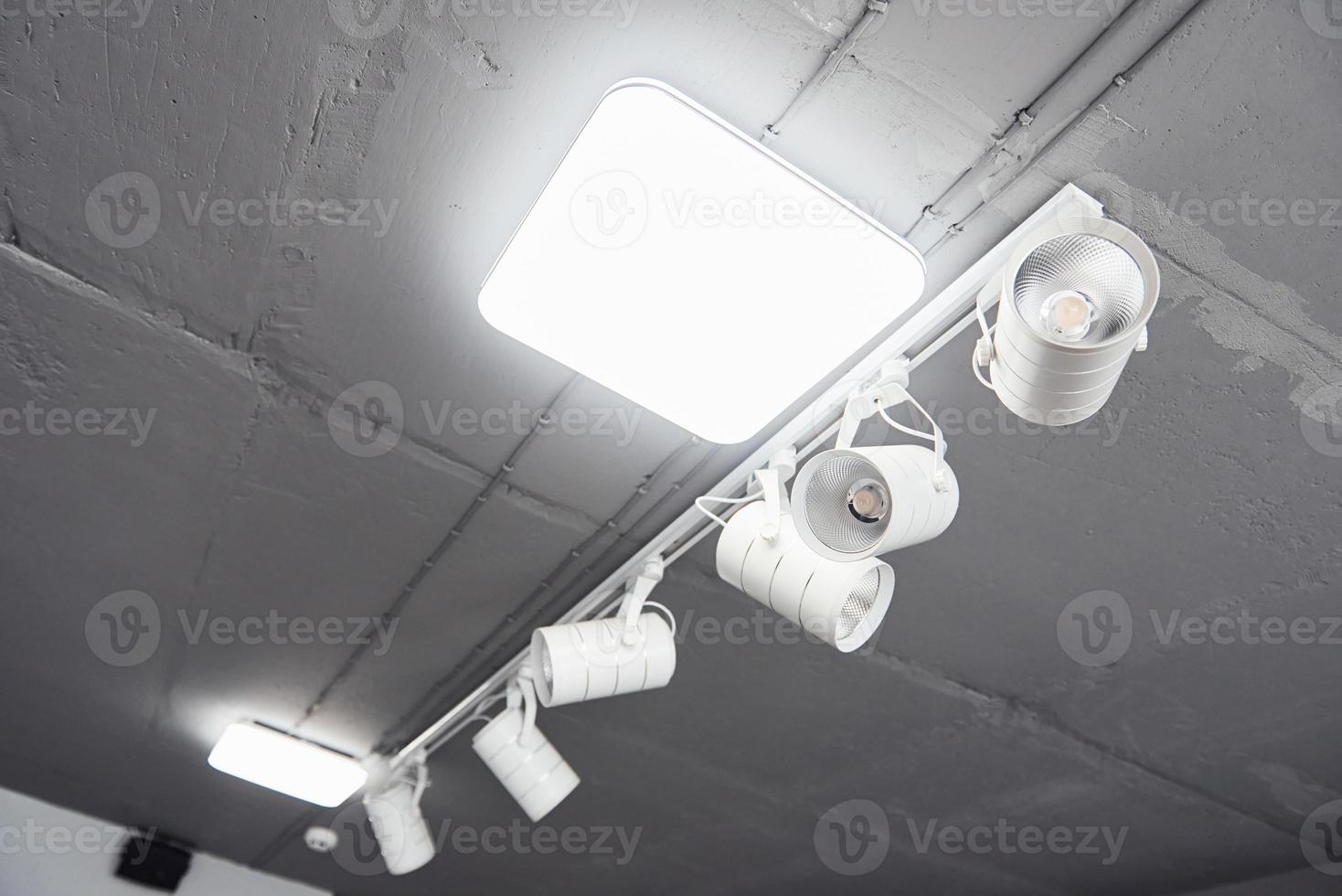 Interior of modern kitchen with light bulbs hanging indoors at daytime photo