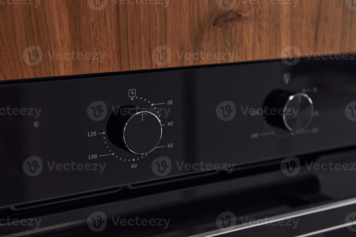 vista de cerca de las perillas de la estufa de gas en el interior de la cocina. material de madera foto