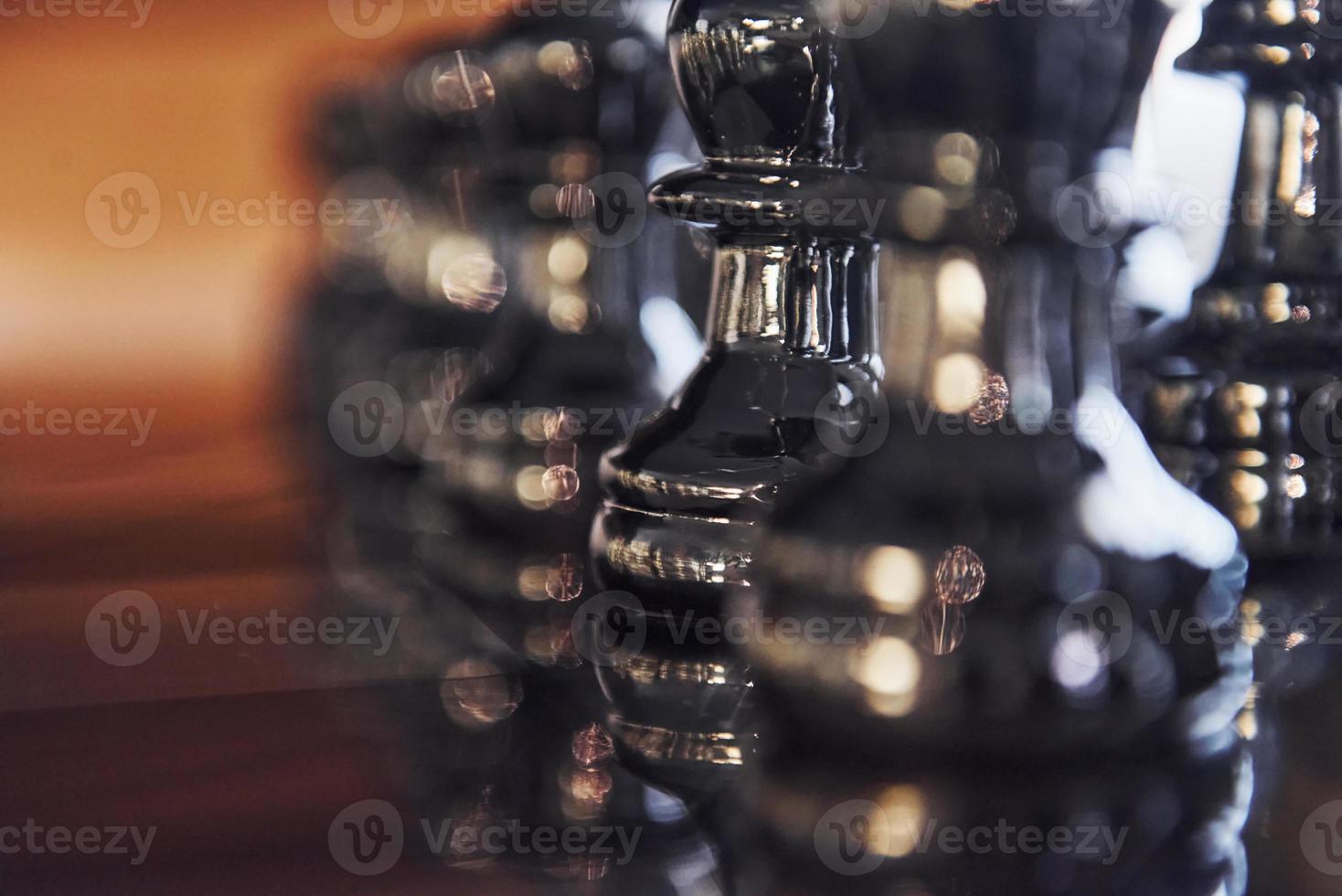 Chess board with metal figures on it indoors on the table at daytime photo