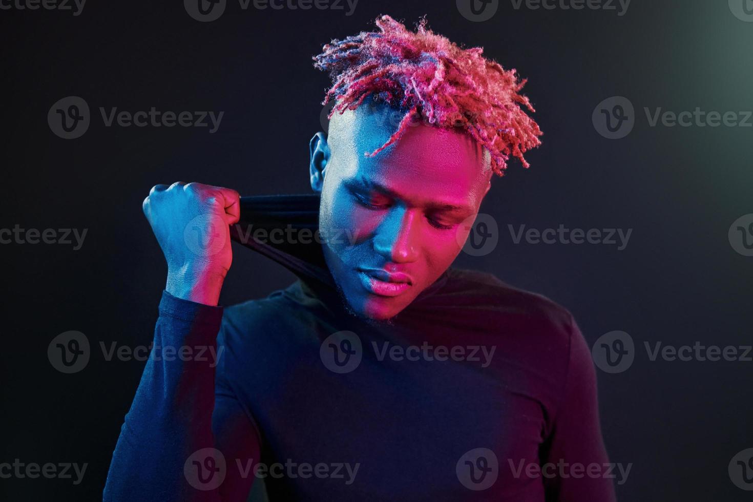 Futuristic neon lighting. Young african american man in the studio photo