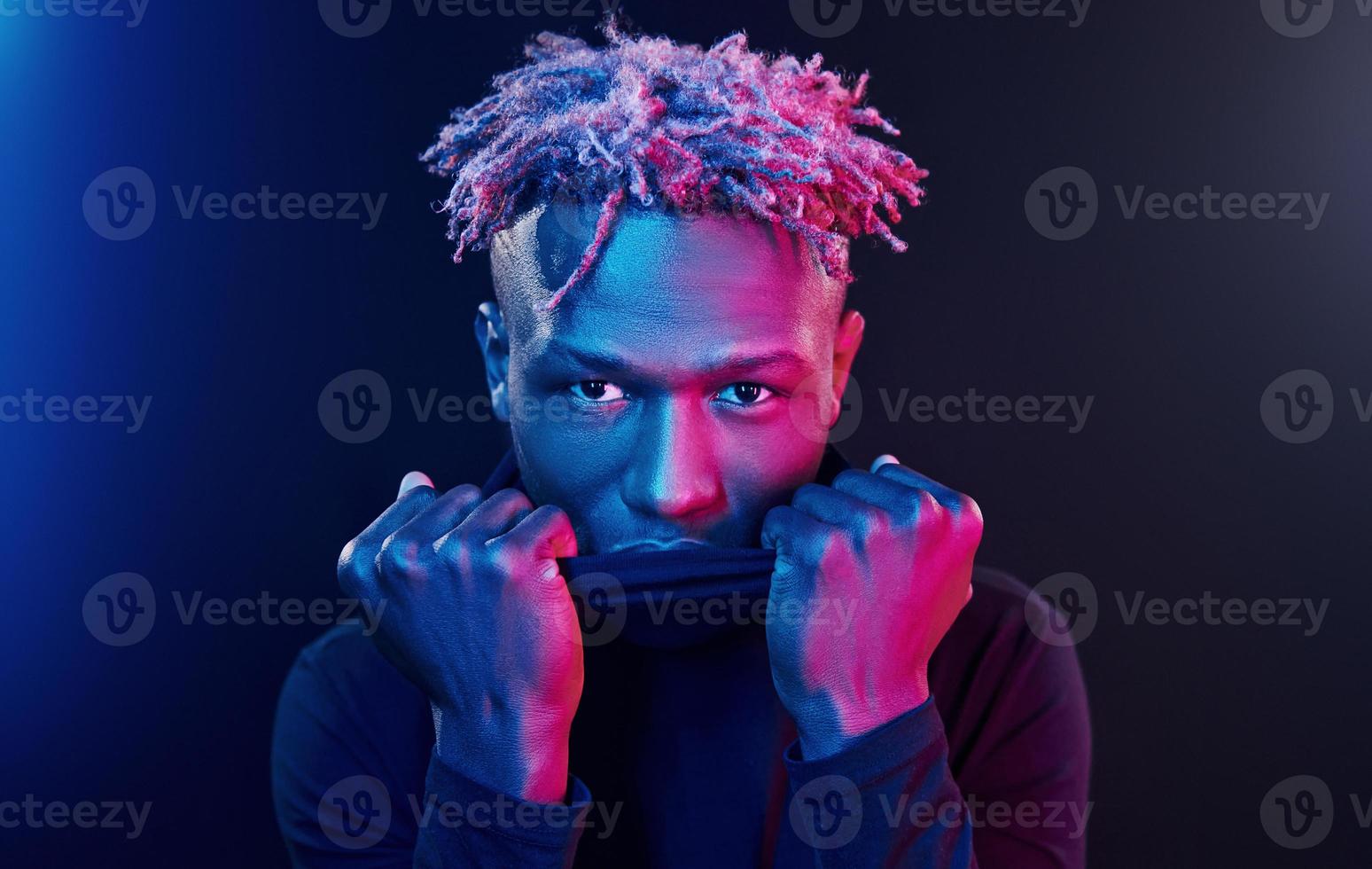 Futuristic neon lighting. Young african american man in the studio photo