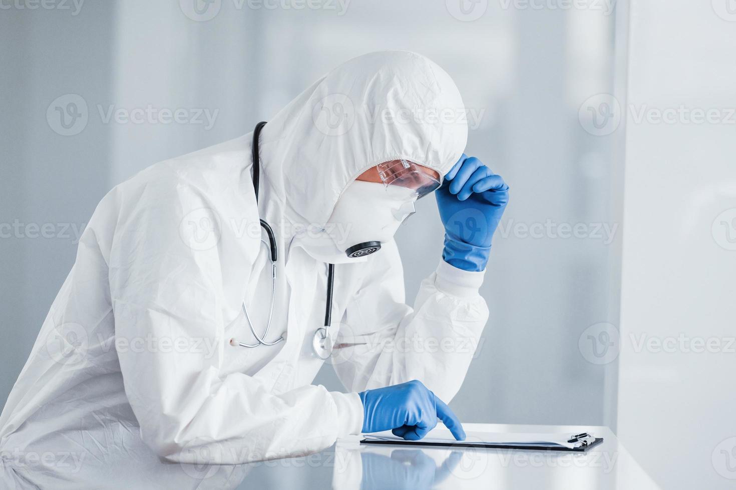 Male doctor scientist in lab coat, defensive eyewear and mask photo