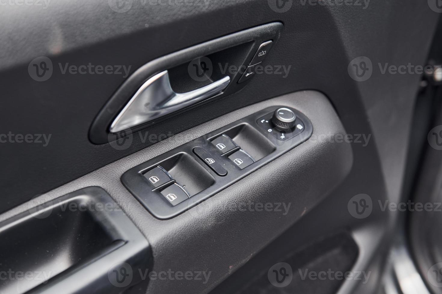 Close up view of modern automobile's door. Buttons and knobs photo