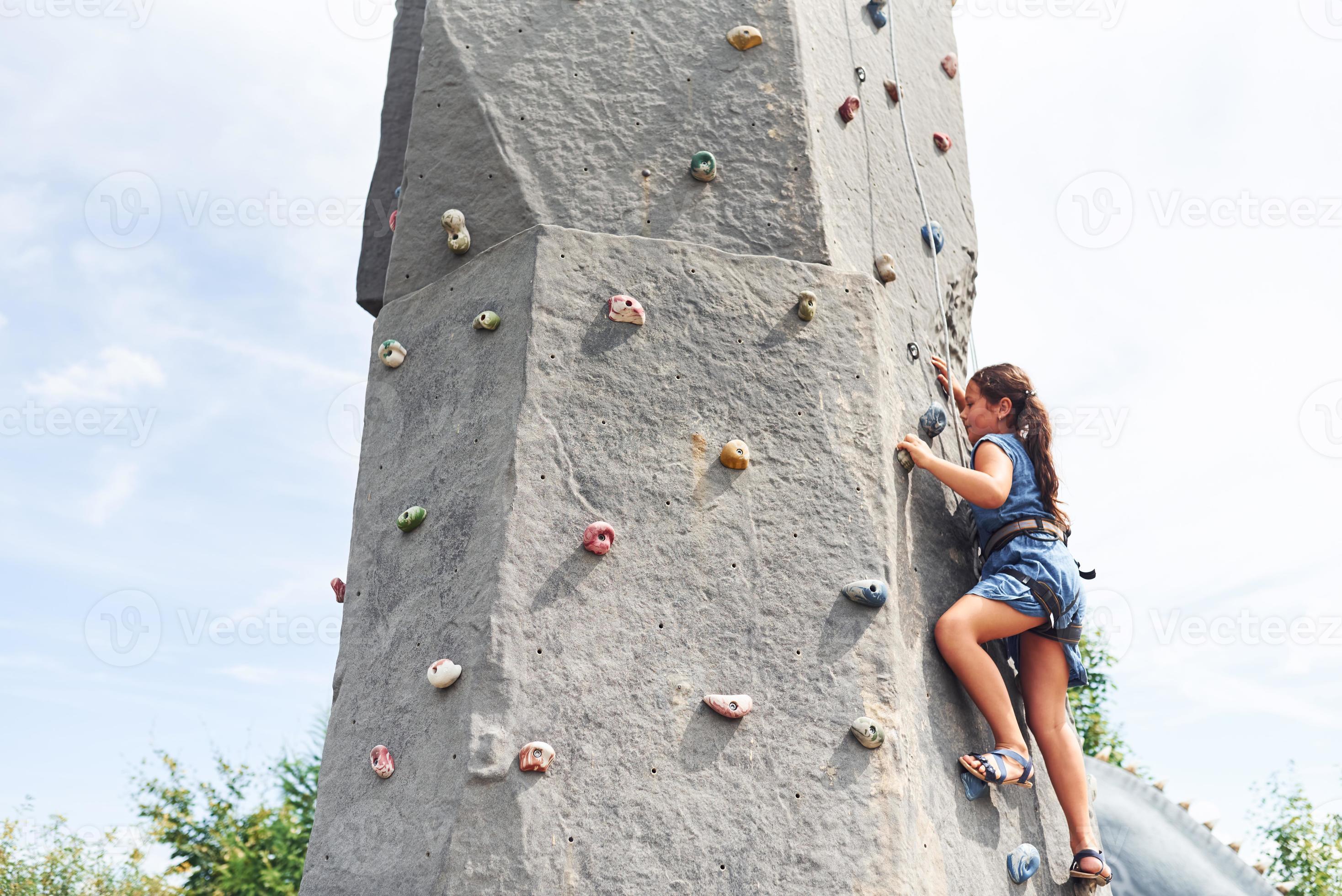 Little girl in casual blue clothes training rock climbing outdoors 15260923  Stock Photo at Vecteezy