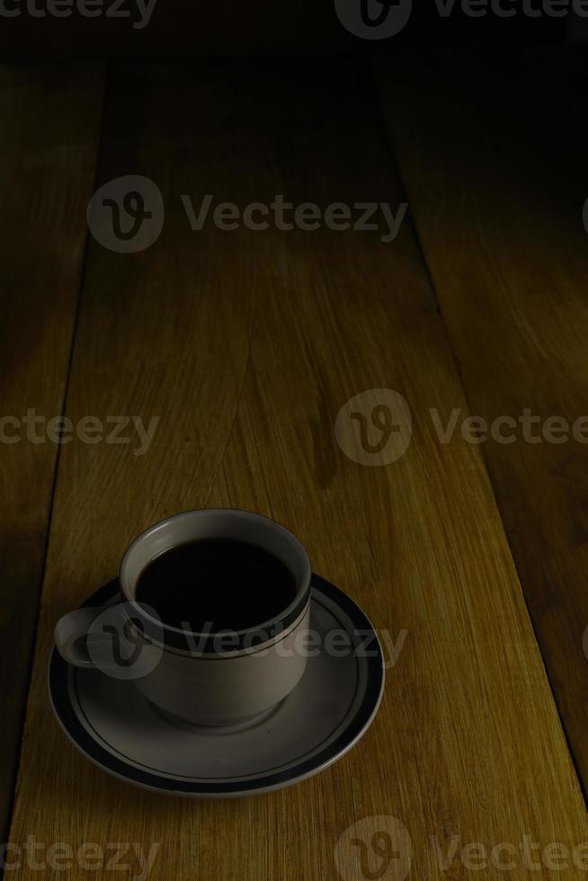 cup of black coffee on a wooden background. copyspace area photo