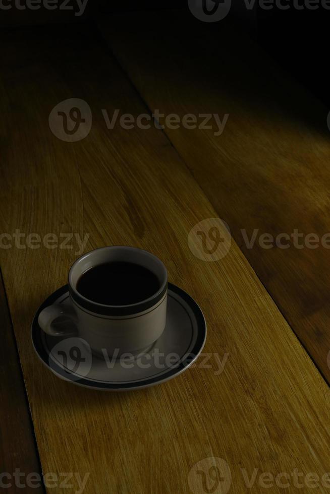 cup of black coffee on a wooden background. copyspace area photo
