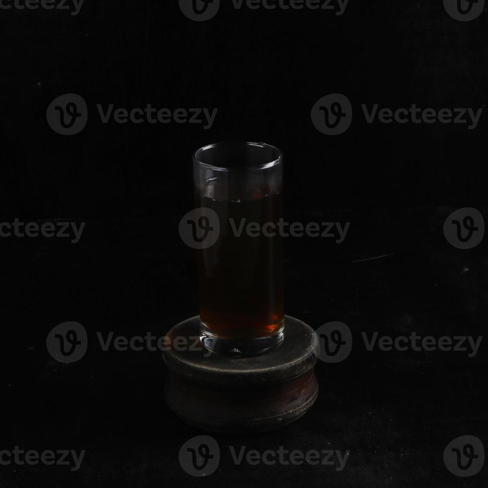 Glass cup of tea on black background photo