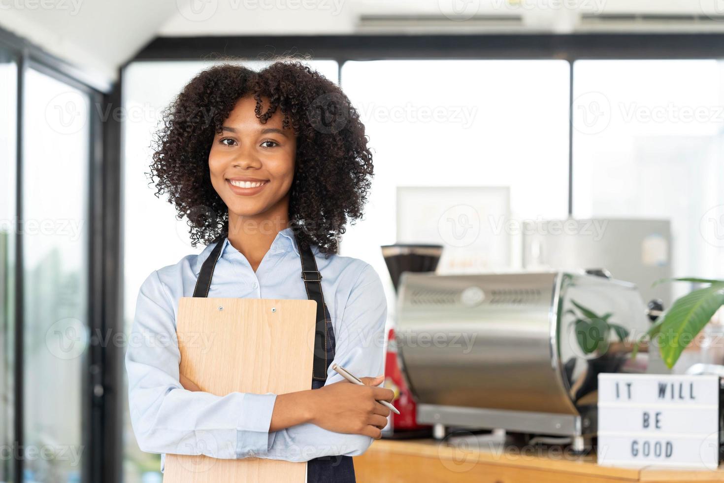 Successful Small Business Startup Small business owner SME Beauty Girl standing in front of a coffee shop with her arms crossed. Picture of an Asian female barista cafe owner. photo