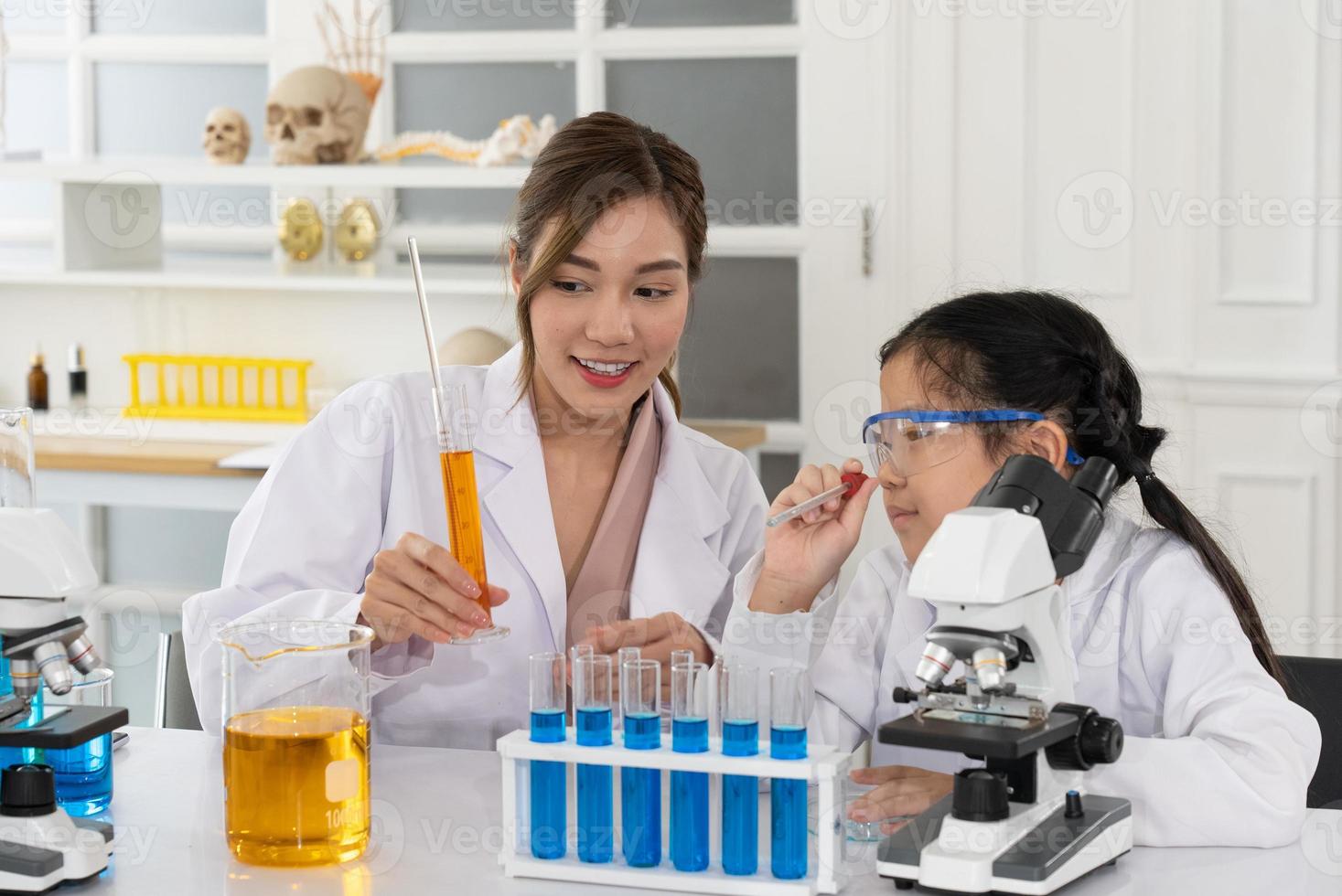 Child Learn Chemistry and Science in Laboratory with Teacher photo