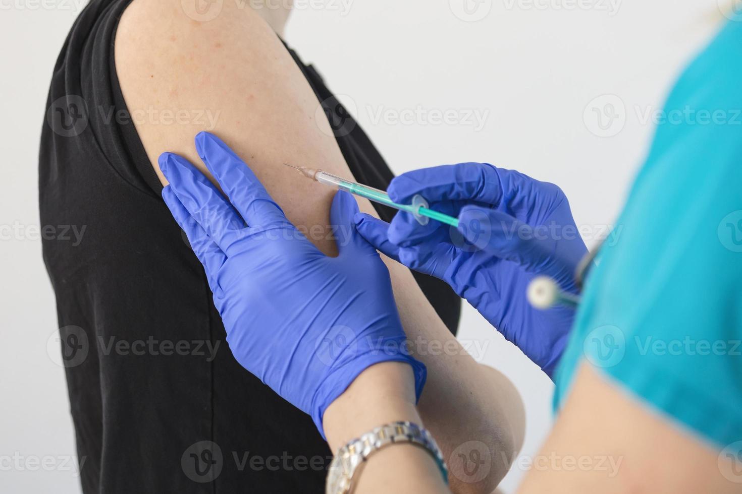 Doctor wearing PPE suit and Surgical mask and use Vaccine with infected patient in quarantine room Covid-19 Coronavirus outbreak or Covid-19, Concept of Covid-19 quarantine photo