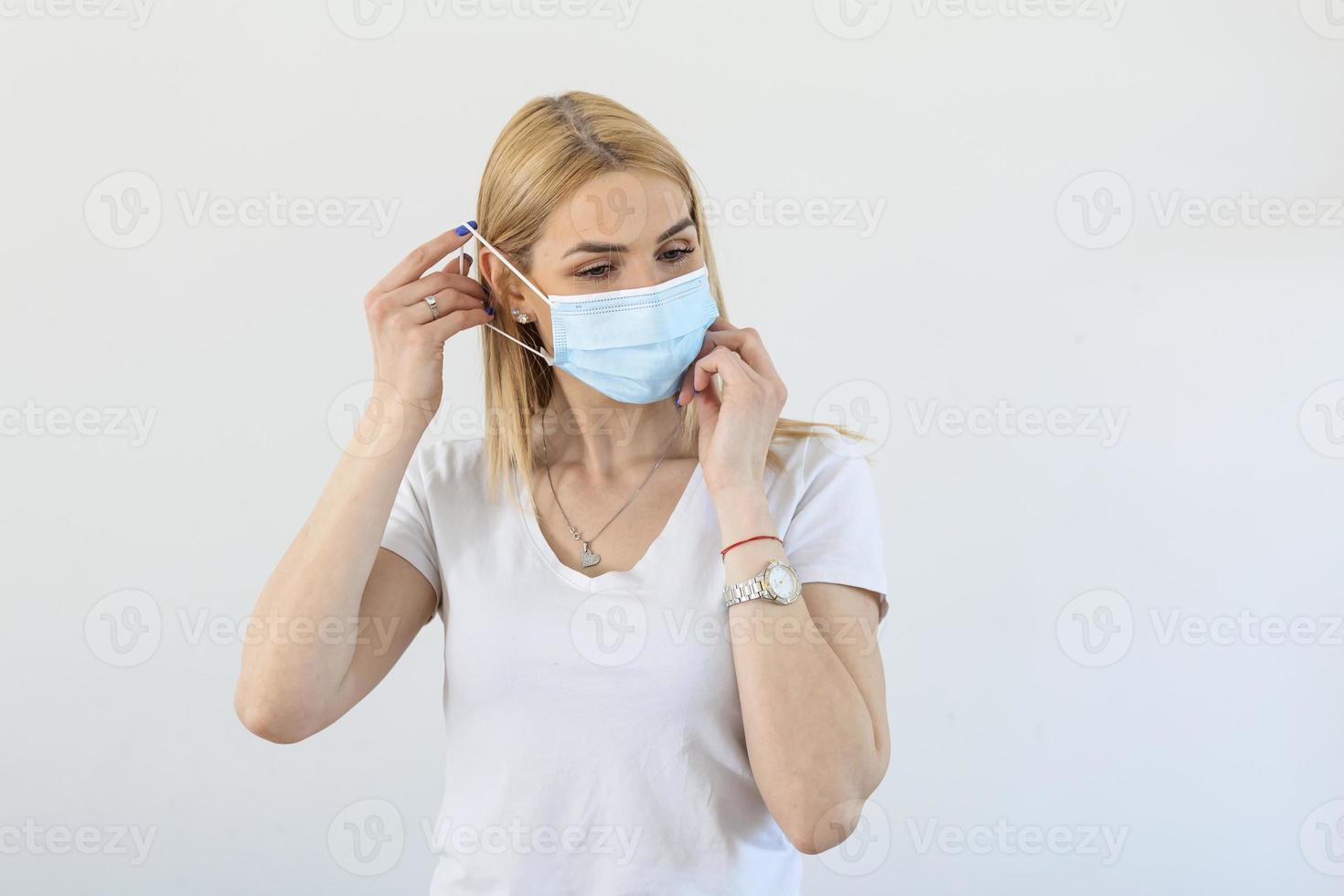 Young woman in respiratory mask. Masked attractive woman putting on protective mask. Cold, flu, virus, tonsillitis, acute respiratory disease, quarantine, epidemic. Covid - 19, coronavirus prevention photo