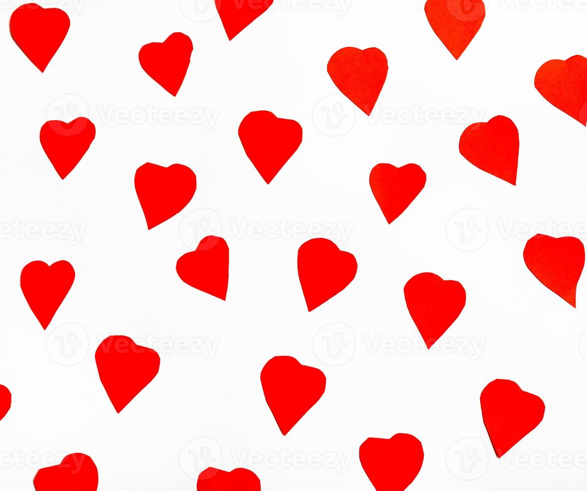 red hearts cut out from paper on white photo