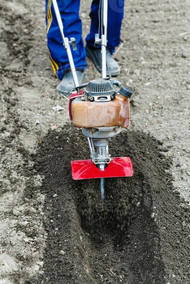 farmer prepares soil for seeding by tiller 15268471 Stock Photo at Vecteezy