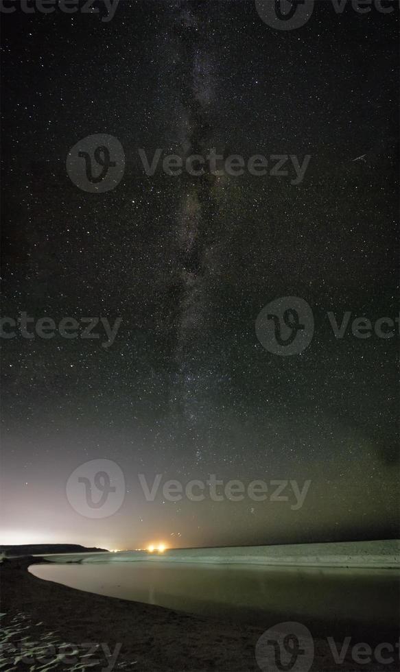 night sky with stars and milky way over beach photo