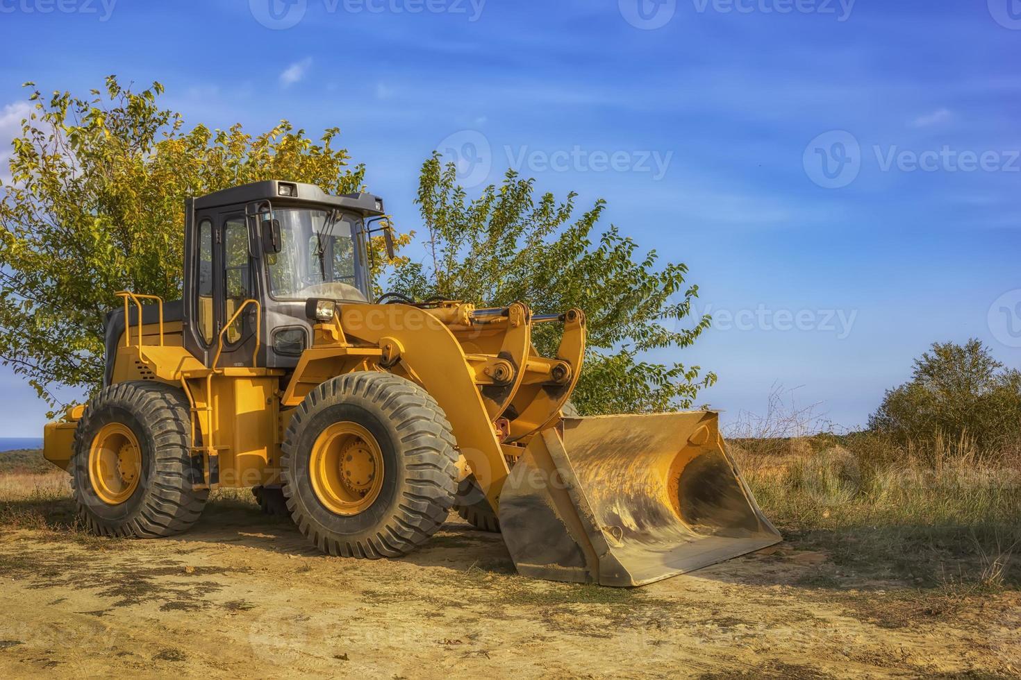 day view of yellow excavator with shovel after work photo