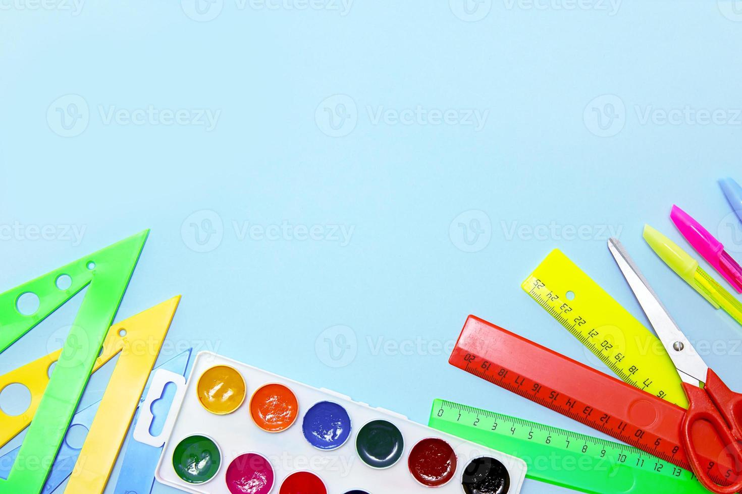 school accessories - triangles, pens, eraser, eraser, watercolor on a blue background with copy space, back to school, school background photo