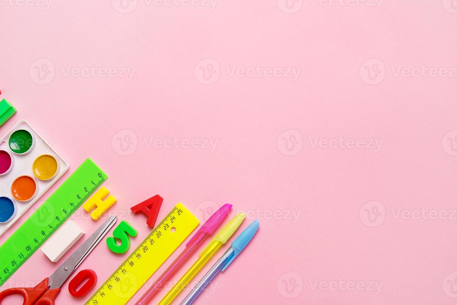 school accessories - rulers, pens, scissors, watercolor on a pink background with copy space, concept back to school, school background photo