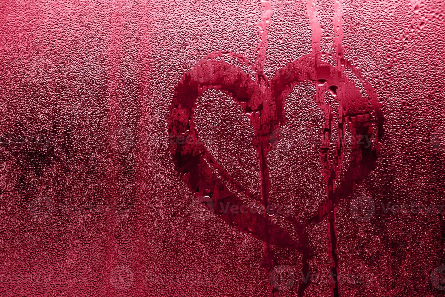 Heart painted on misted glass. Valentines day, Color of the year 2023 - Viva Magenta photo