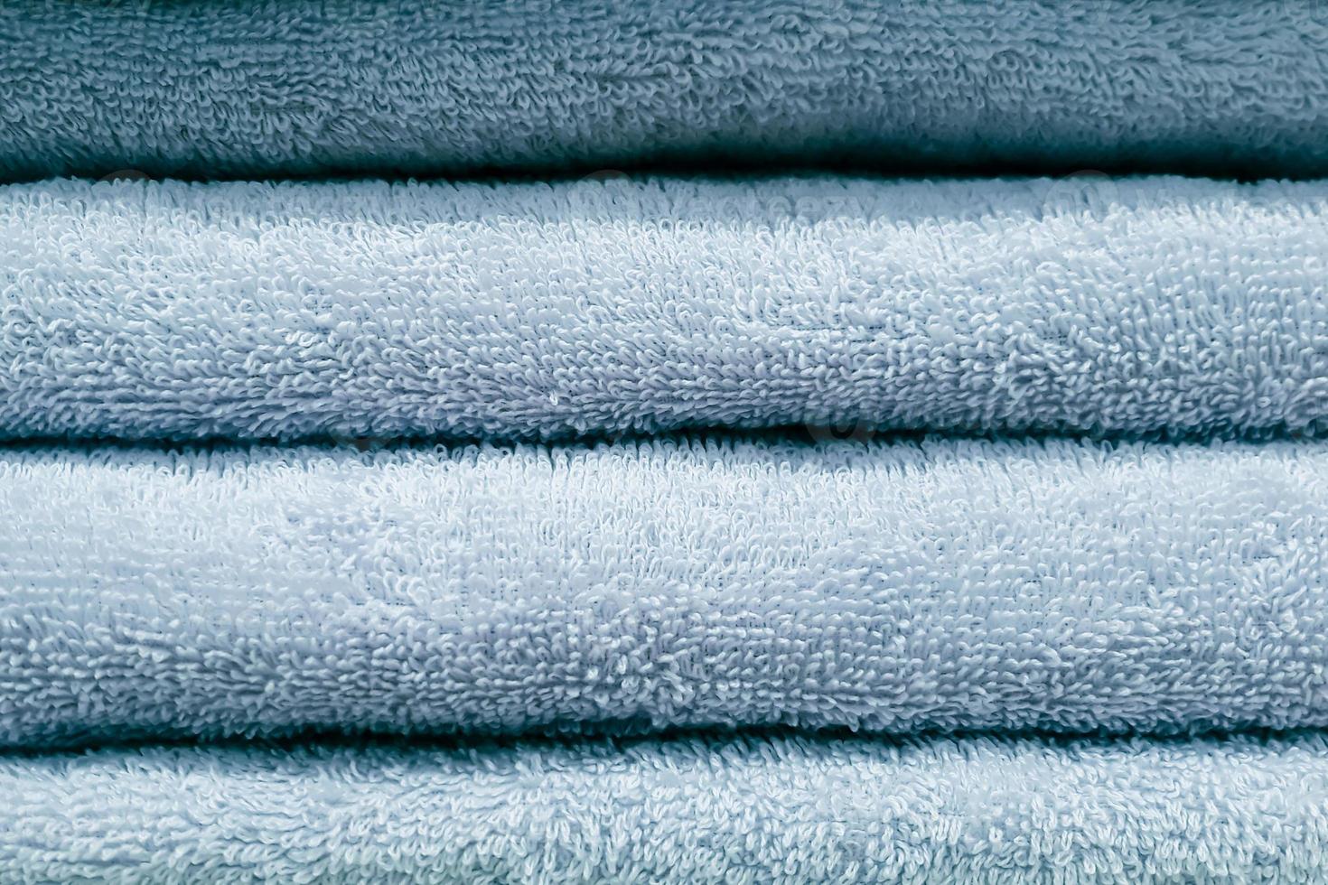 Stack of bath towels. Home textiles for spa treatments. Soft fluffy fabric. photo