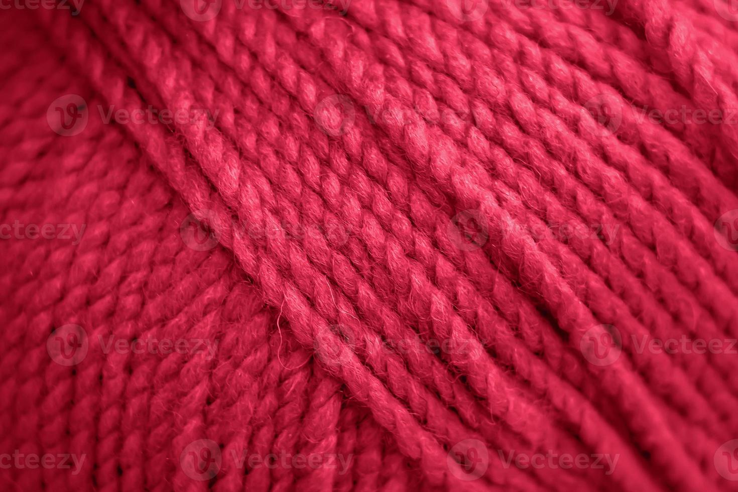 Texture of pink fluffy woolen threads for knitting. Color of the year 2023 - Viva Magenta photo