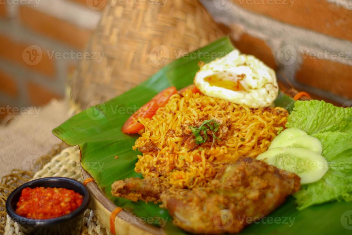 spicy noodle food with additional omelet and fried chicken photo