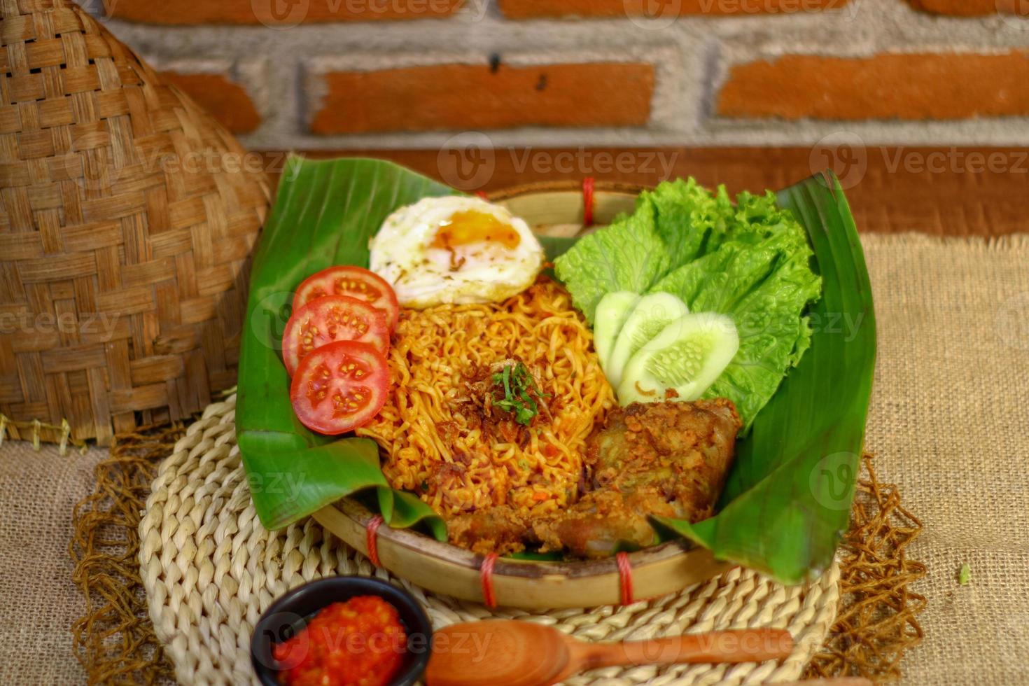 spicy noodle food with additional omelet and fried chicken photo