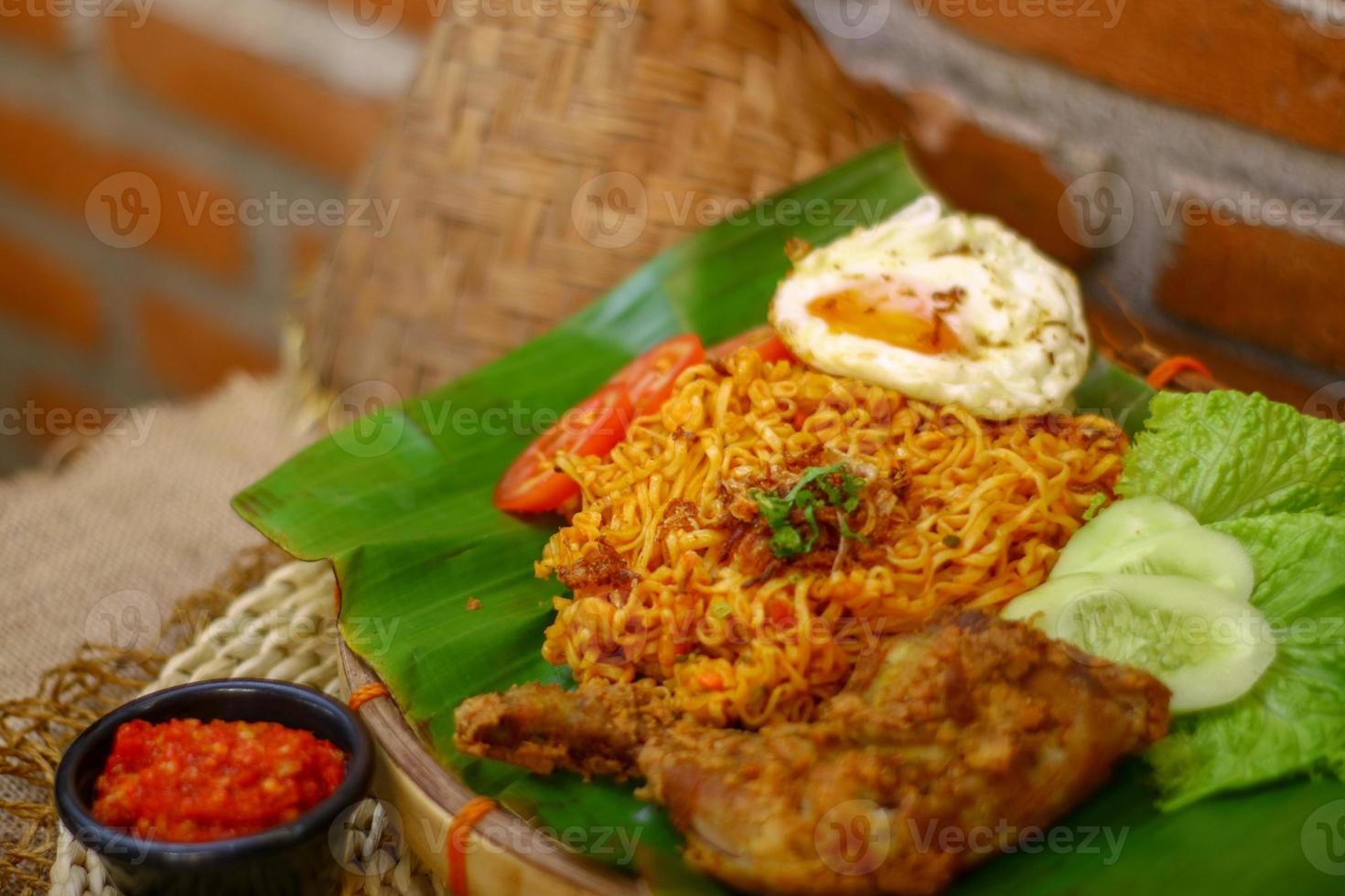 spicy noodle food with additional omelet and fried chicken photo