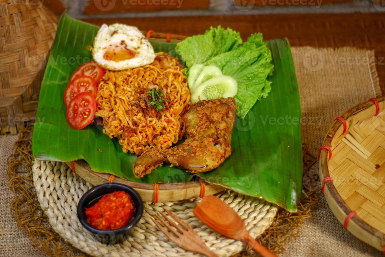 spicy noodle food with additional omelet and fried chicken photo