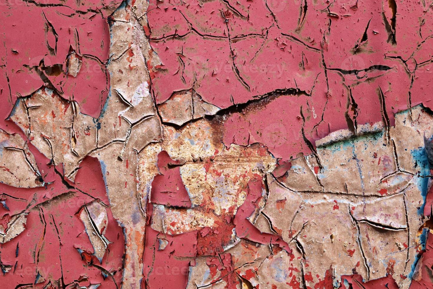 Detailed and colorful close up at cracked and peeling paint on concrete wall textures in high resolution photo