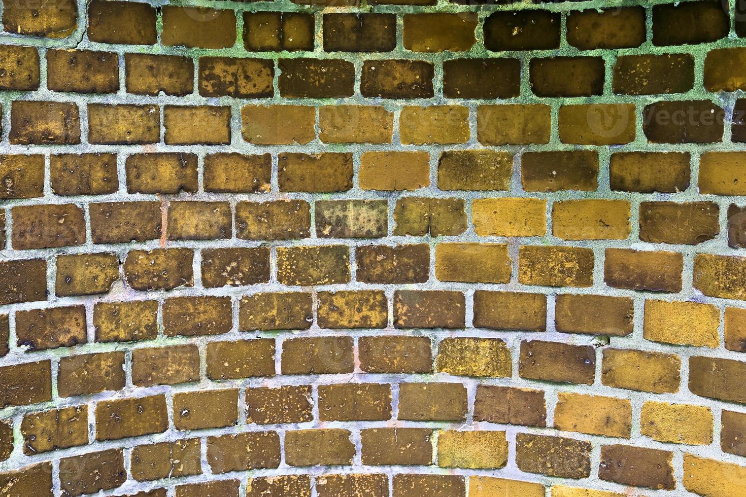 Detailed view at a colorful old and weathered brick wall texture as a panoramic background. photo