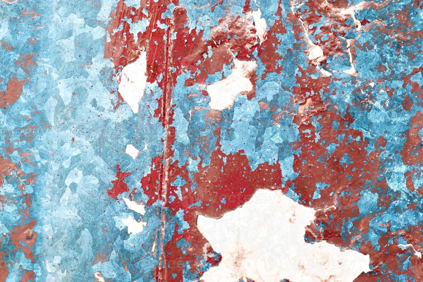 Detailed and colorful close up at cracked and peeling paint on concrete wall textures in high resolution photo