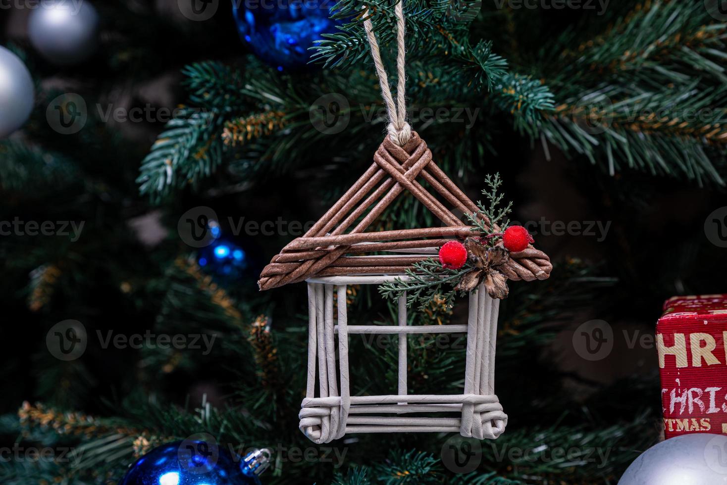 christmas tree with colorful balls and gift boxes over white brick wall with blue and white balls photo