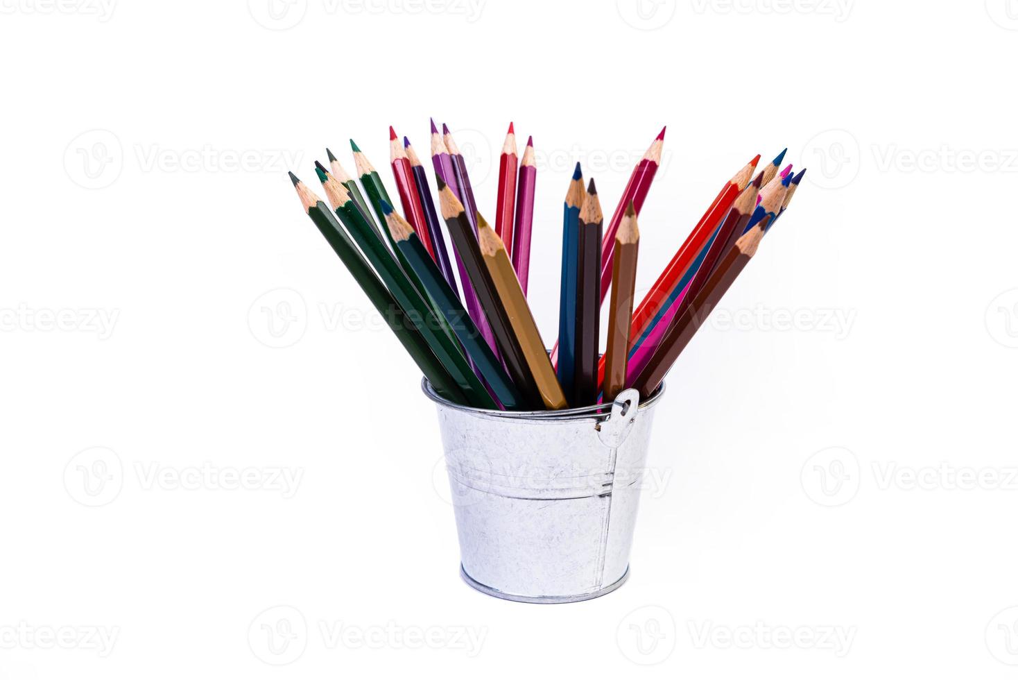 multi-colored pencils in a wine glass and a bucket. Selective blurred a group of coloring pencils in a wine glass on the isolated white or black background , Modern art. Modern photo