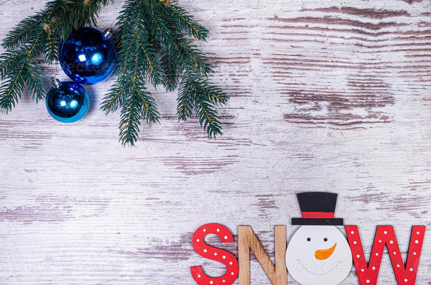 Flat lay composition with serpentine streamers and Christmas decor on wooden background. Space for text Balls, branches, hat, photo