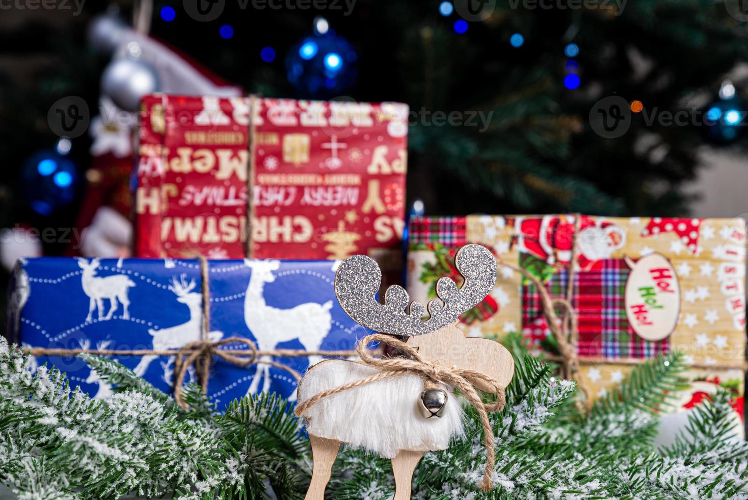 knitted elk. cute moose. toy against the background of a New Year's garland, knitted hare and elk on a Christmas tree photo