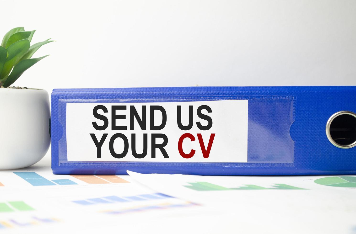 paper folder with send us your cv words and charts photo