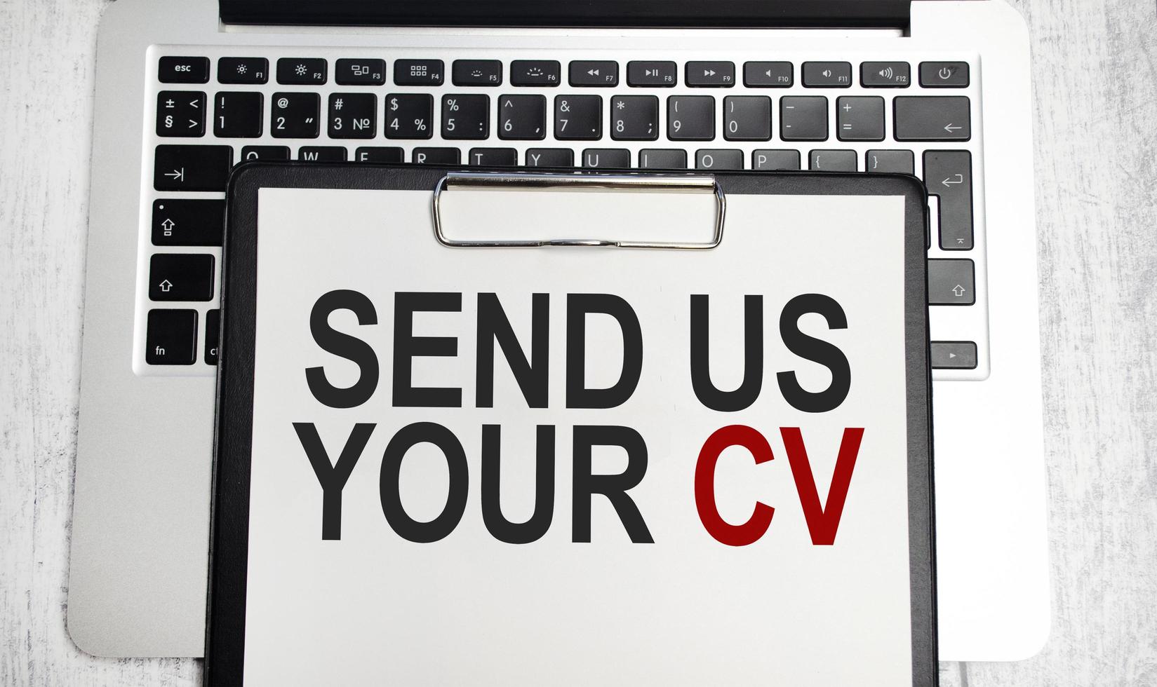 send us your cv words on paper tablet on laptop photo