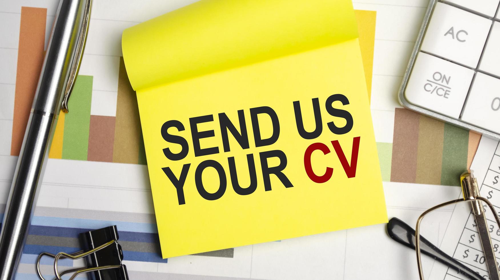 yellow sticker , charts, pen and send us your cv words photo