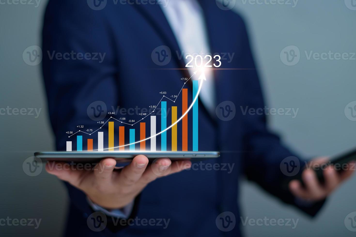 Businessman analysis profitability of working companies with digital augmented reality graphics, positive indicators in 2023, businessman calculates financial data for long term investments. photo