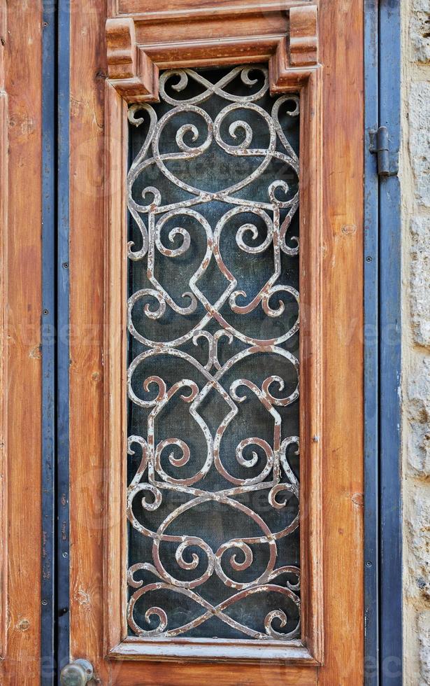 Wooden door with metal bars in old Jaffa photo