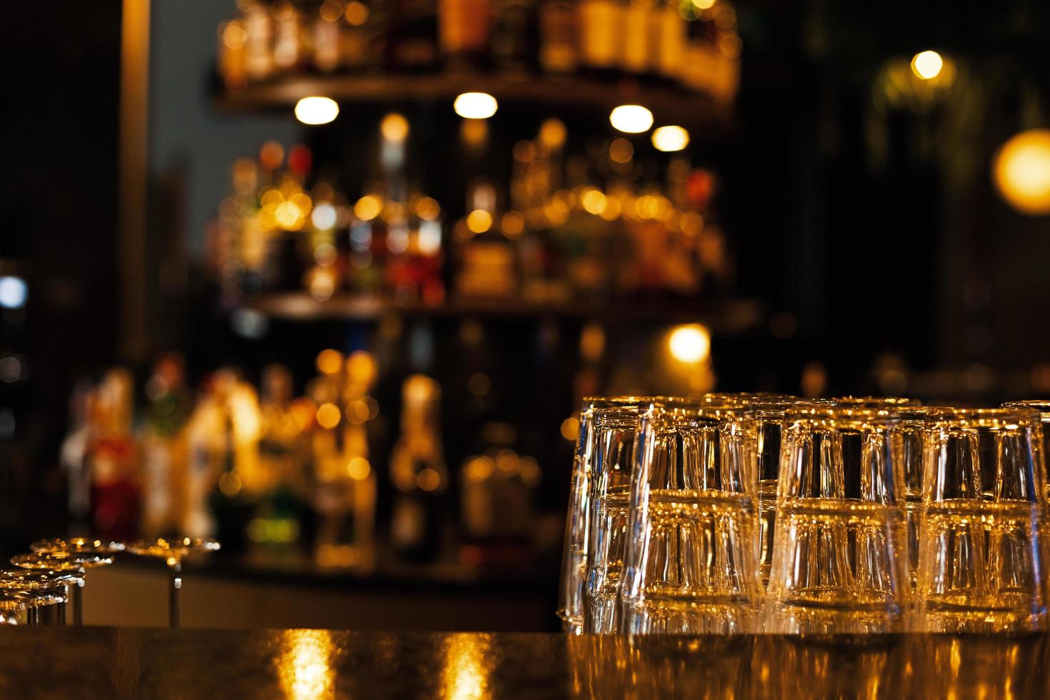 Lower the top of the wooden table with blurred racks and bottles Background For mounting the product display or visual photo