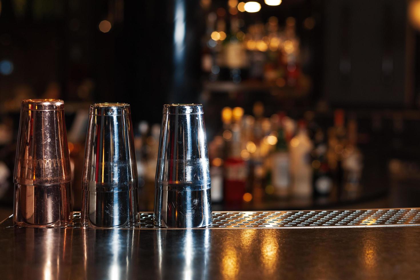 Lower the top of the wooden table with blurred racks and bottles Background For mounting the product display or visual photo