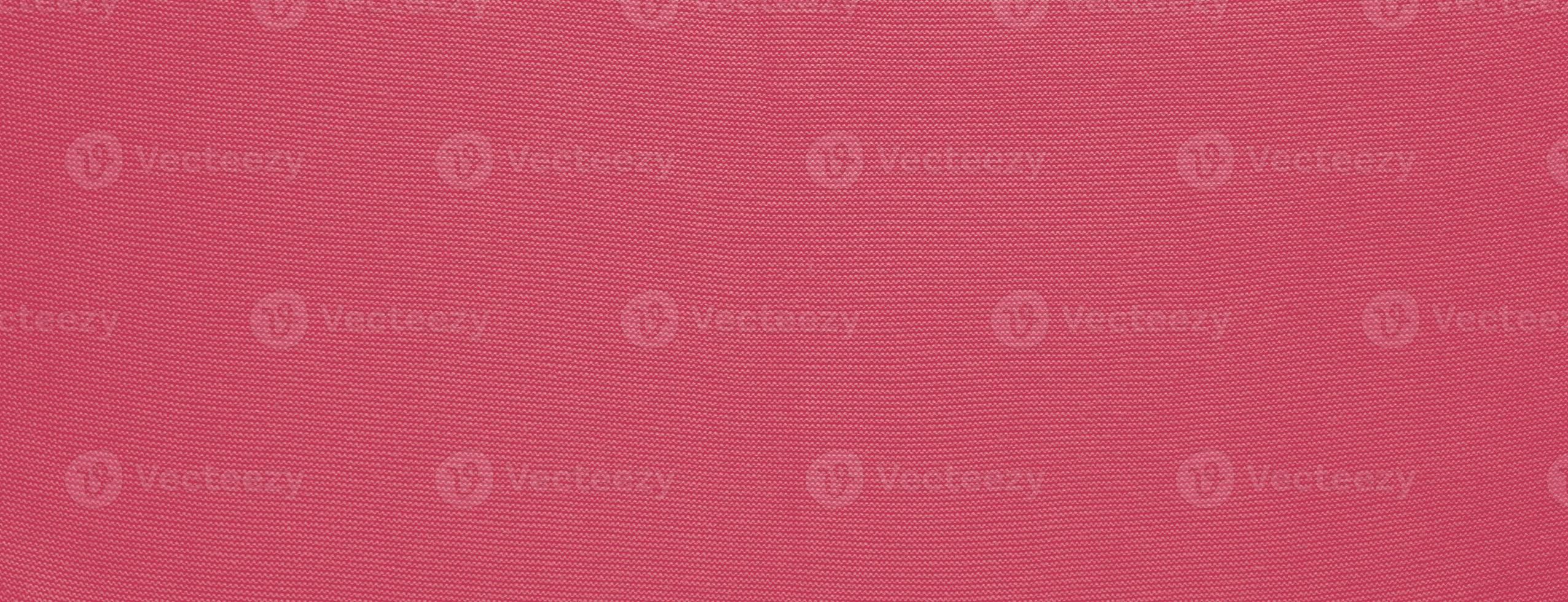 Texture of smooth knitted sweater with pattern. Handmade knitting wool or cotton fabric texture. Background of Large knit pattern with knitting needle or crochet. Color Of The Year 2023 - Viva Magenta photo