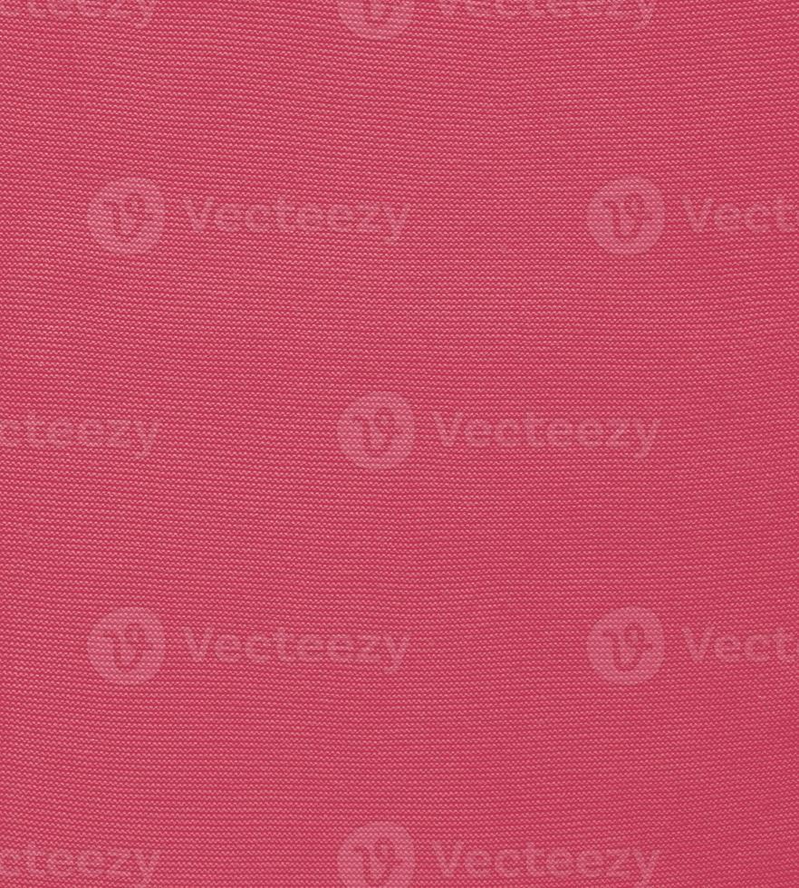 Texture of smooth knitted sweater with pattern. Handmade knitting wool or cotton fabric texture. Background of Large knit pattern with knitting needle or crochet. Color Of The Year 2023 - Viva Magenta photo