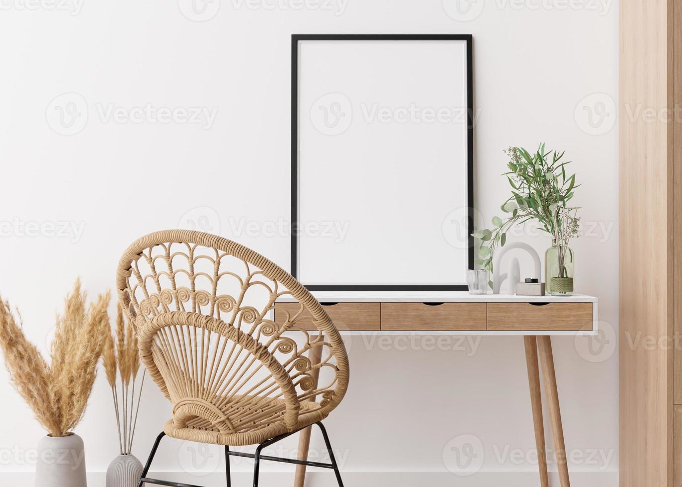 Empty vertical picture frame standing on wooden desk in modern living room. Mock up interior in contemporary, boho style. Free, copy space for your picture. Vase, pampas grass, rattan chair. 3D render photo