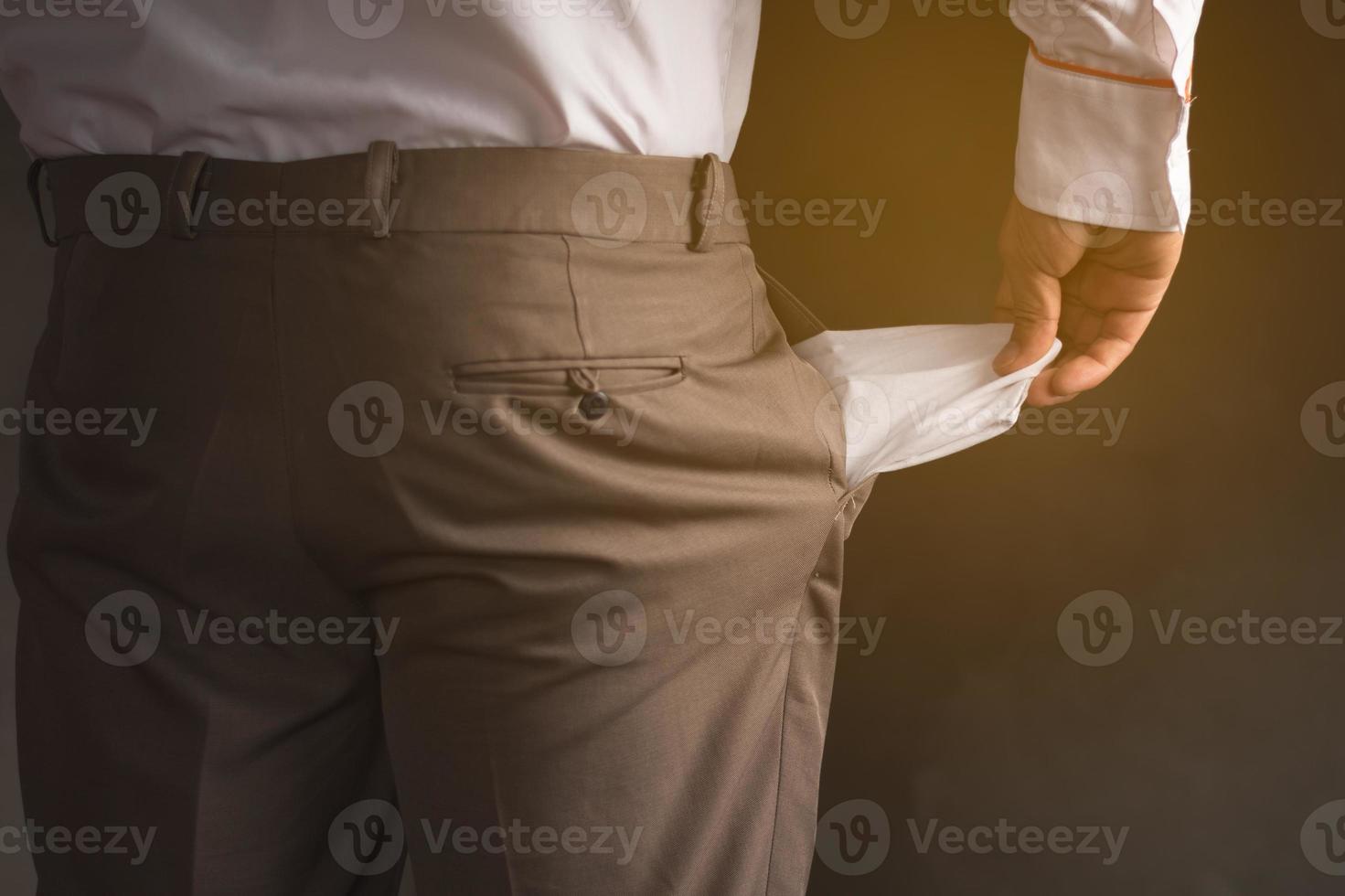 A business man with empty pants bag, financial crisis and poor income economy photo